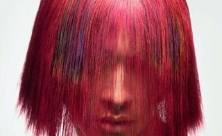 Model with dyed red hair, example of Colour Alchemy colour-changing hair dye