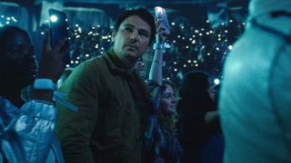 Josh Hartnett looking at something uneasily during a pop concert in Trap.