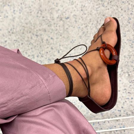 Woman wearing brown tie sandal