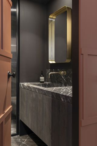 Dark marble spa bathroom designed by TR Studio