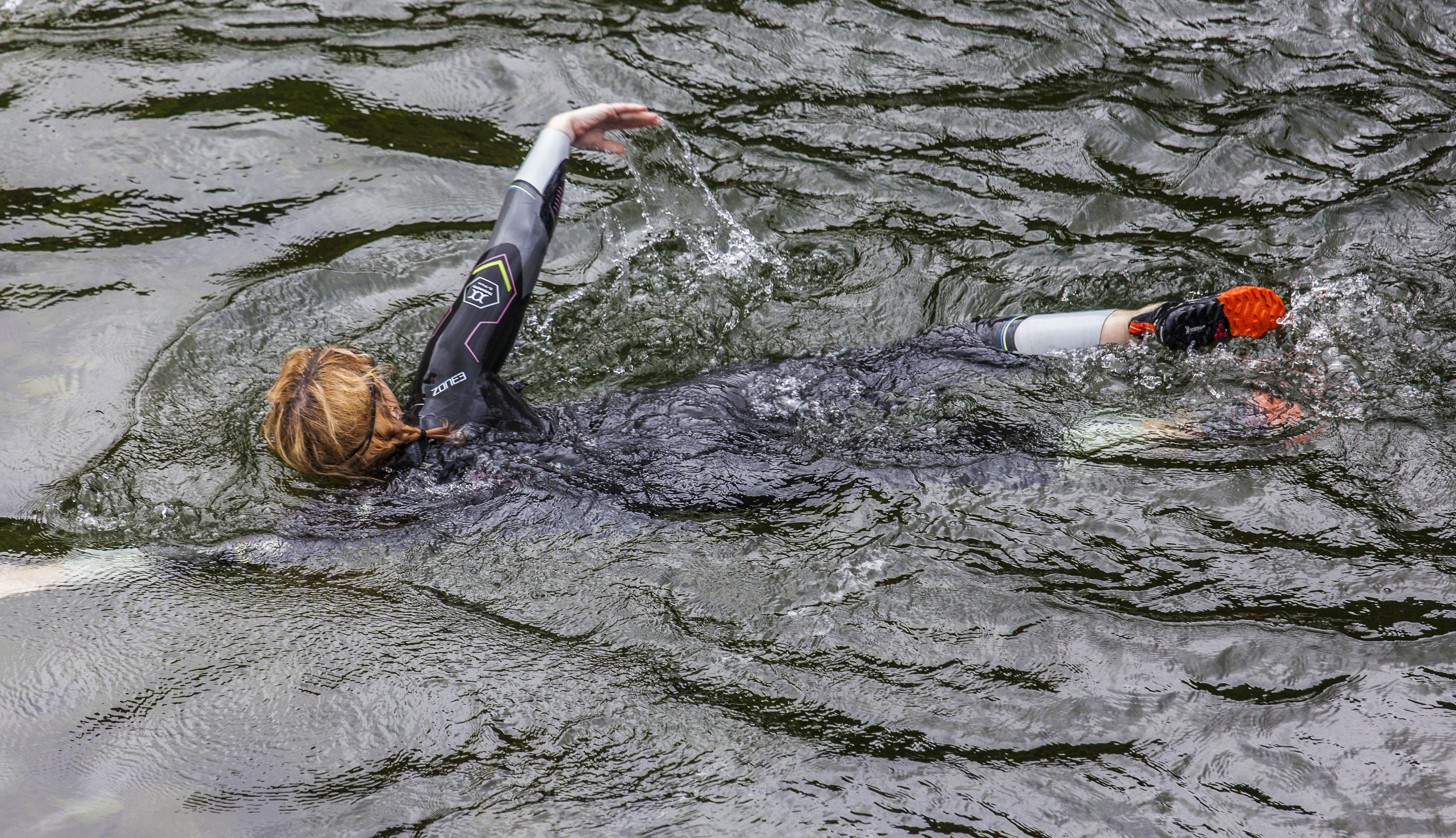 Swimmer wearing a wetsuit in the River Esk