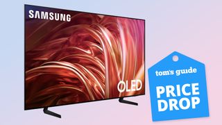 The Samsung S85D OLED TV displaying colorful, abstract imagery next to a badge that reads: "Tom's Guide Price Drop"