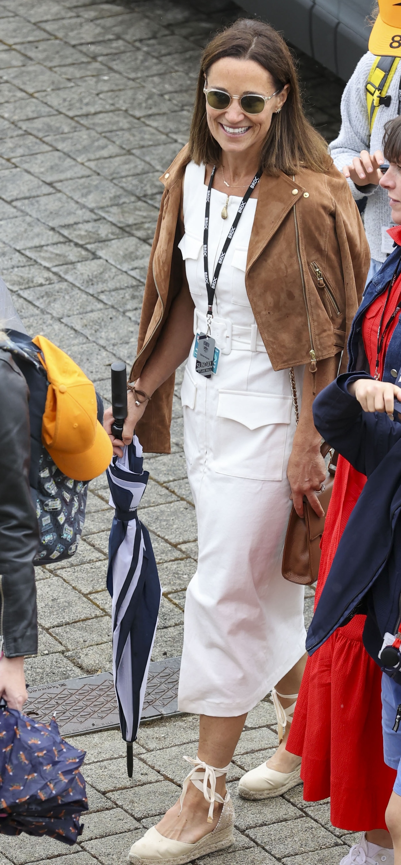 Pippa Middleton wearing Castaner espadrilles and a white dress with a brown jacket at the British Grand PRix