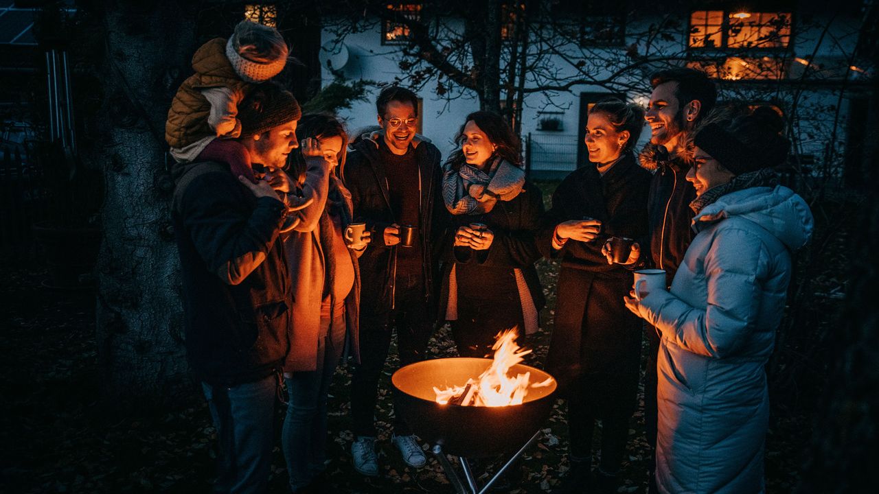 people gathered around a Hofats fire bowl