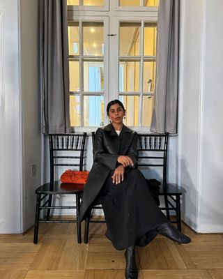 Monikh wears a maxi skirt, knitted top and knee high boots