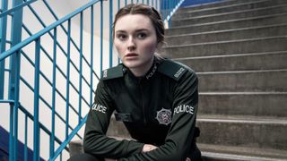 Annie (Katherine Devlin) in uniform sitting on the stairs in Blue Lights