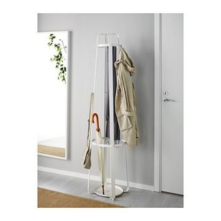 Enudden Hat and Coat Stand made of white galvanised steel in a room in between a door and mirror, with a coat, scarf and bag hanging off it and an umbrella in the stand