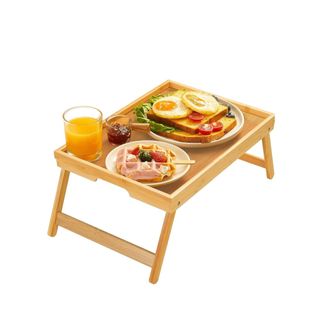 A wooden bed tray with a breakfast spread on it