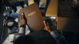 Watson holding his Casebook of Sherlock Holmes