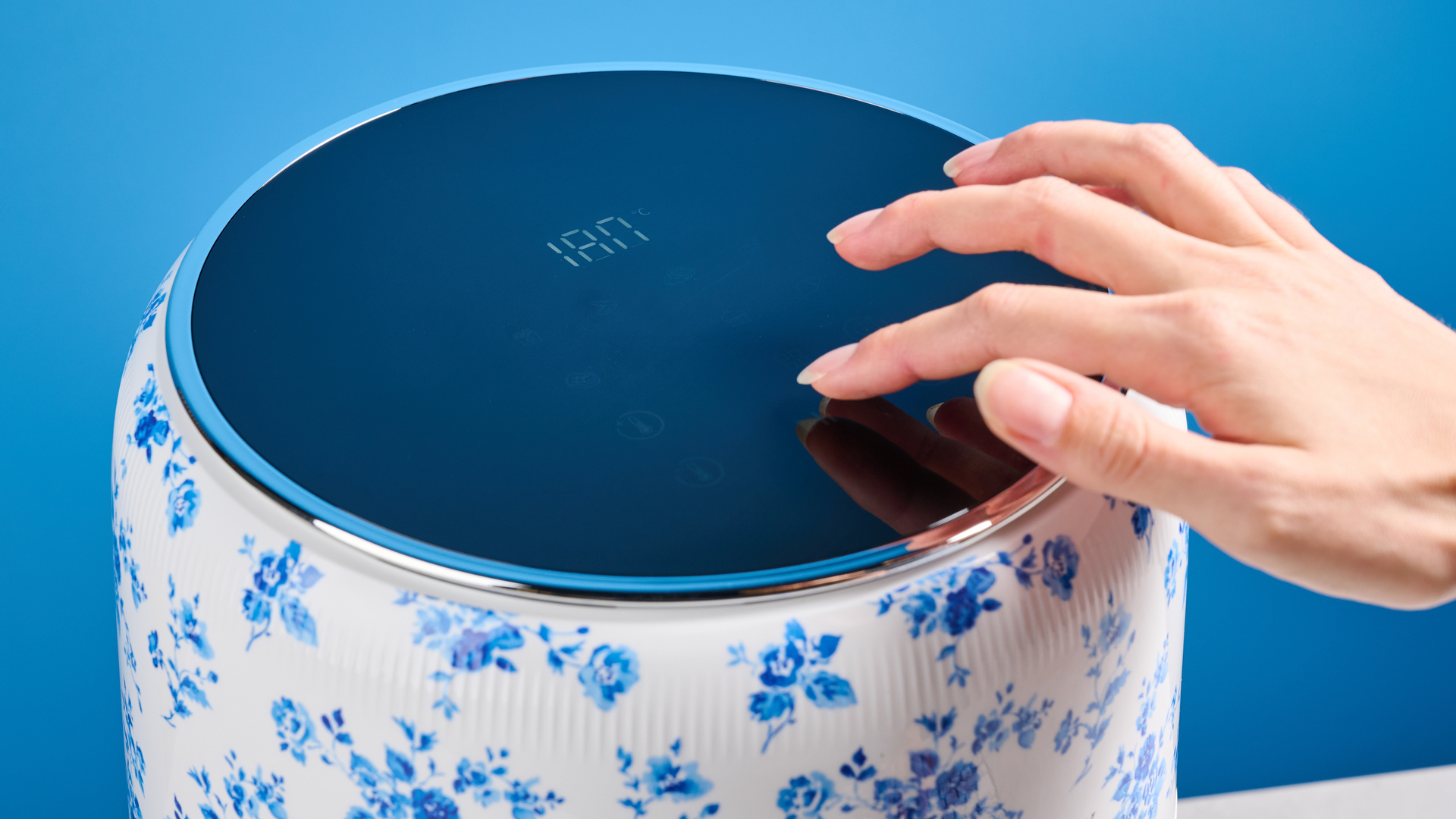 the Laura Ashley Air Fryer in blue and white floral print, showing the air fryer basket and black touchscreen on the top