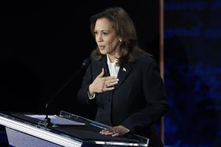 kamala harris debating in a black suit