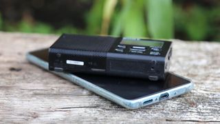 the sony xdr-p1 dab radio on top of a smartphone