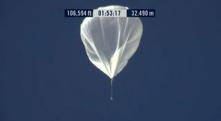 The balloon carrying skydiver Felix Baumgartner up 23 miles (37 km) passes the 100,000-foot mark during the Red Bull Stratos mission to break the record for the world's highest skydive on Oct. 14, 2012.