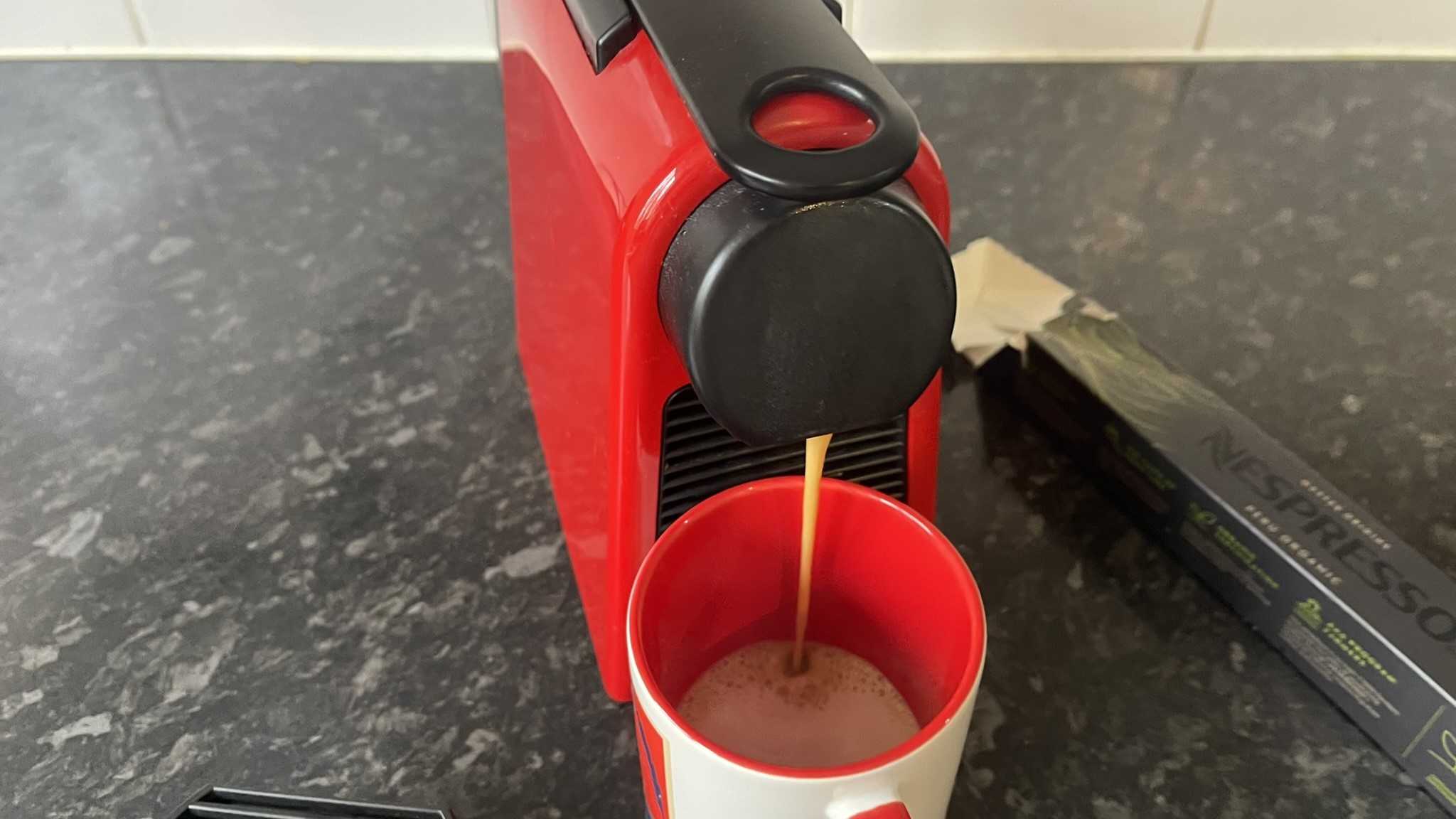 Nespresso Essenza Mini pouring coffee