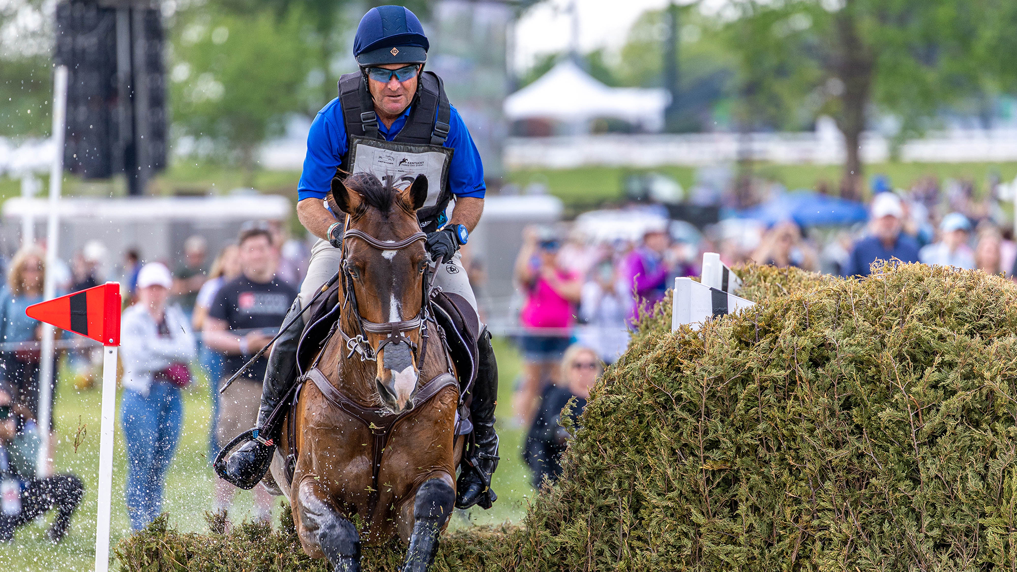 Phillip Dutton and Possante jump a brush fence on the cross-country at Kentucky Three-Day Event 2026