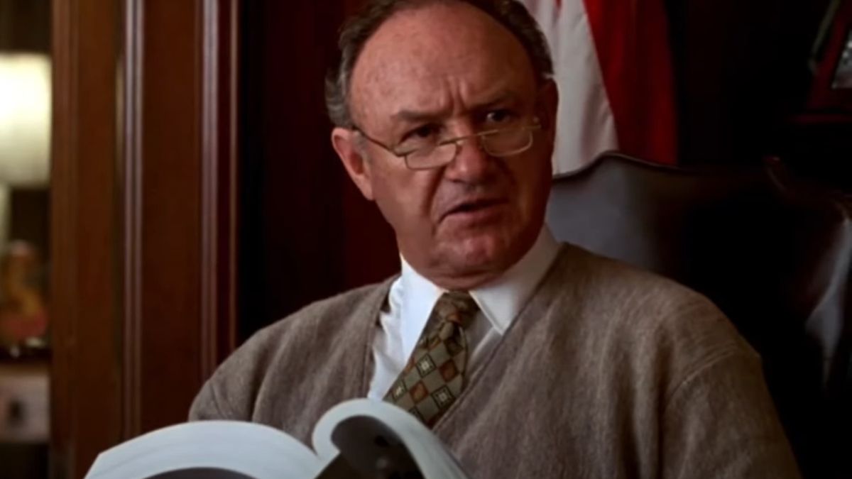 Gene Hackman looks up from a report while sitting in The Birdcage.