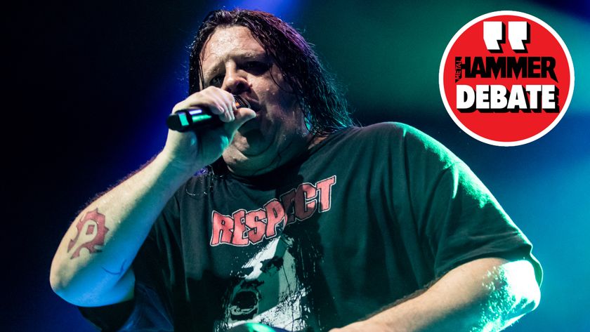 Cannibal Corpse singer Corpsegrinder onstage in 2023, with a logo saying &quot;Hammer Debate&quot; in-set