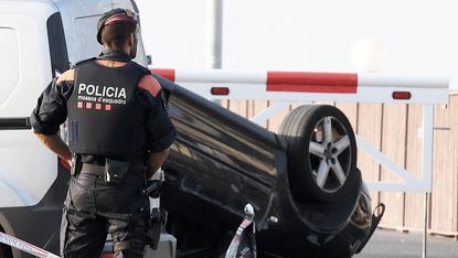 Police guard the car allegedly used in the attack in Cambrils