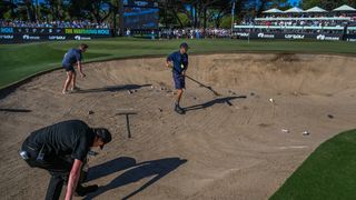 Bottles and cups are cleared from a bunker at LIV Golf Adelaide