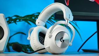 The Logitech G Pro X3 Lightspeed headset in white, on a stone surface.