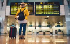 Young woman at the airport in Barcelona checking for the flight schedule