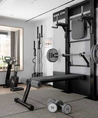 A home gym in a white room with black gym equiptment