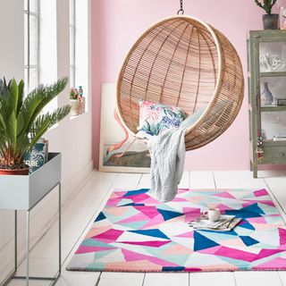 room with pink wall and accessorize rug