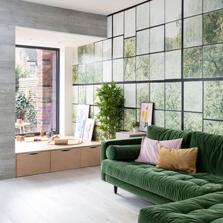 Green sofa and a picture wall in an east london semi detached house