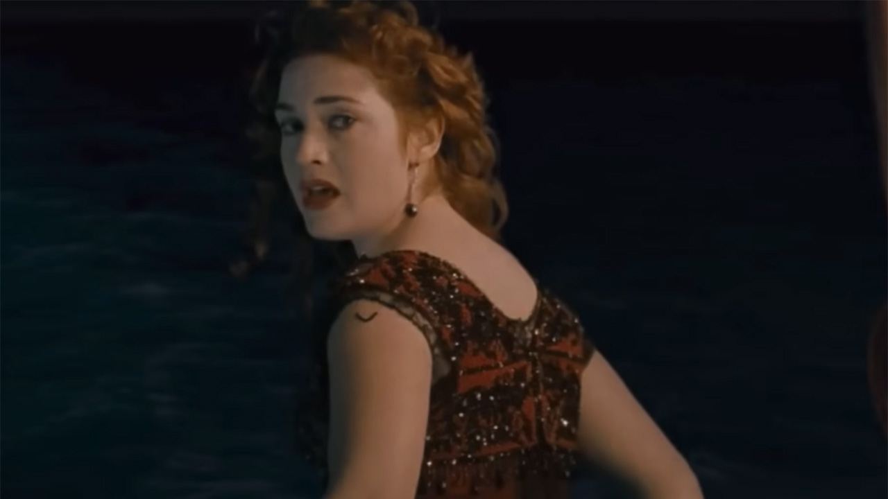 Kate Winslet in red and black dress about to jump in Titanic.