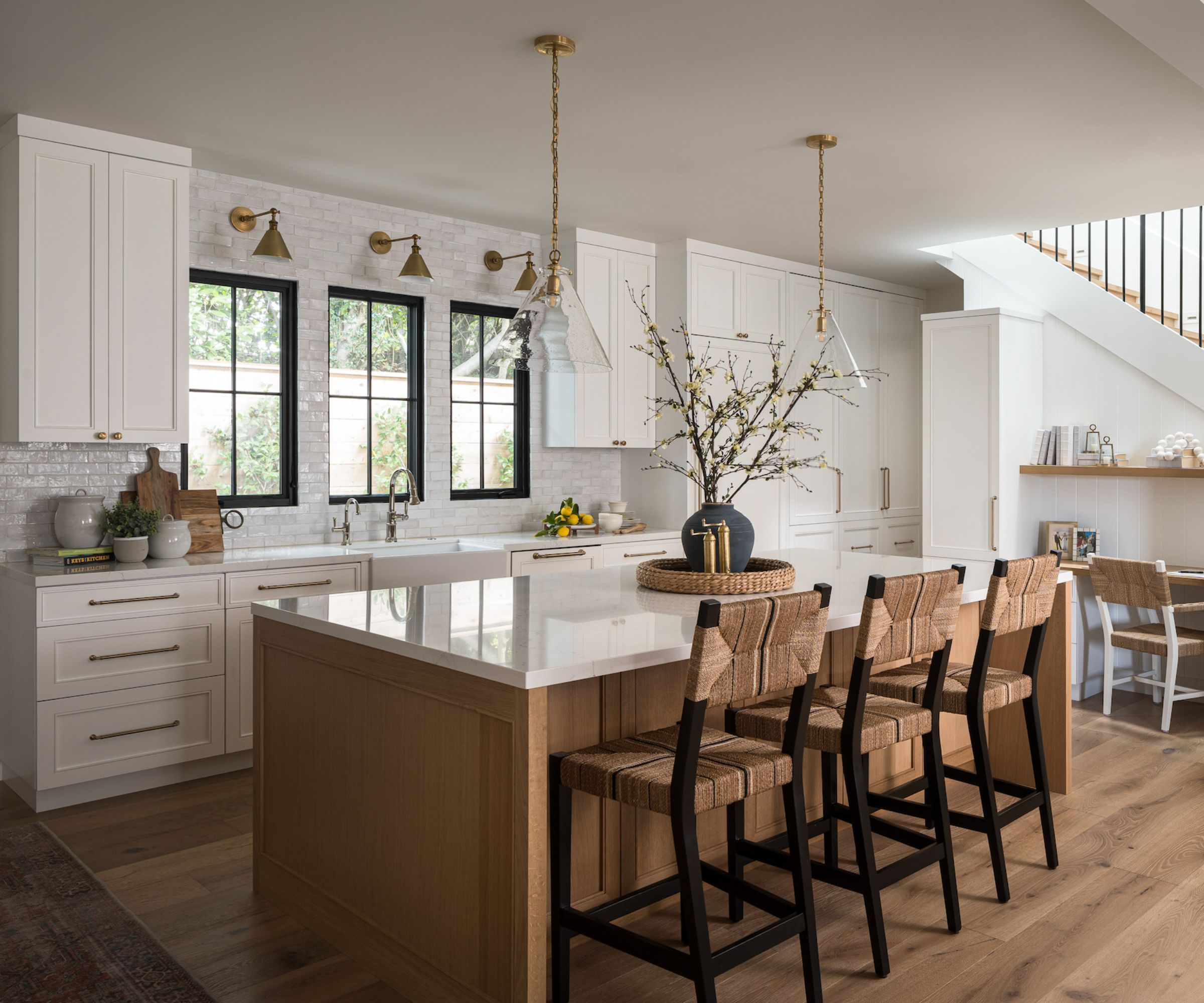 A white kitchen with a wooden island