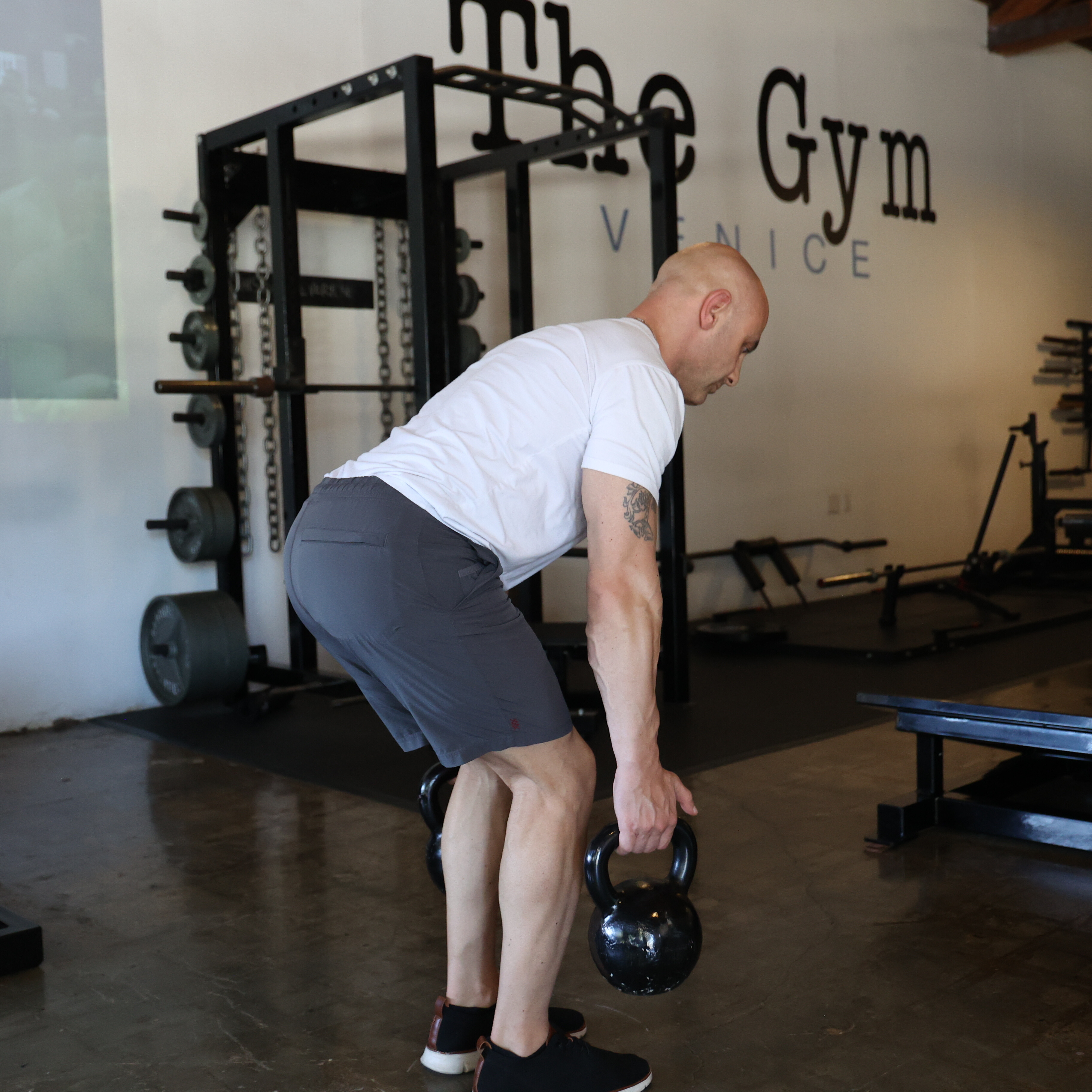 Man exercising in gym with kettlebell