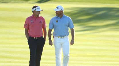 Ian Poulter and Lee Westwood talking during Day 1 of the 2020 Abu Dhabi HSBC Championship