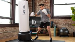 A person punching the FightCamp bag