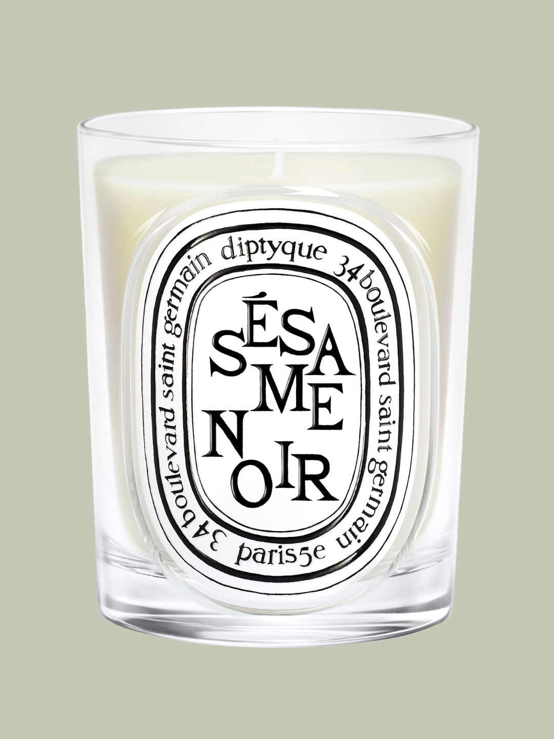 A black sesame-scented candle from Diptyque in a glass vessel