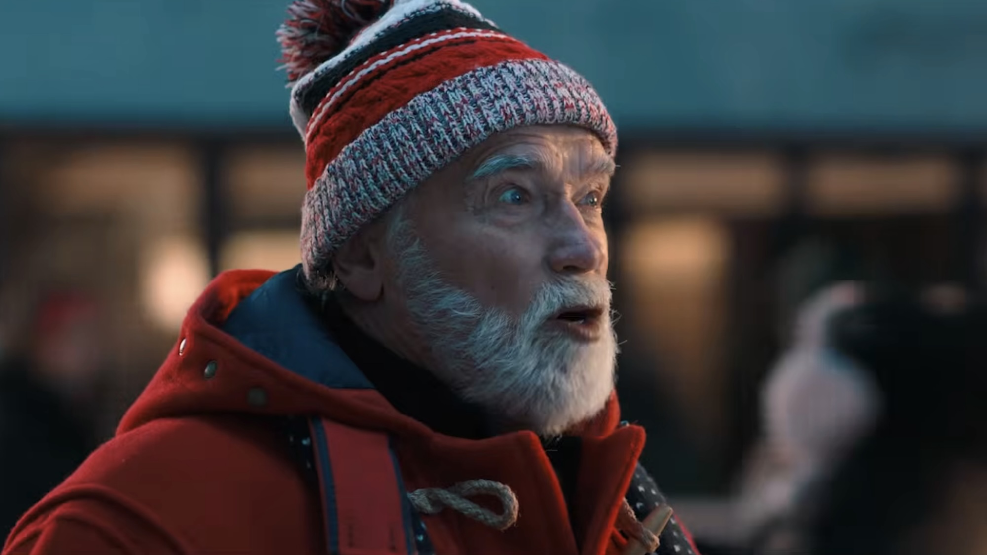 Arnold's Santa wearing a beanie and a red jacket in the teaser for The Man with the Bag.