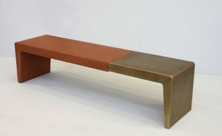 bench that fuses carefully carved leather, bronze and brass