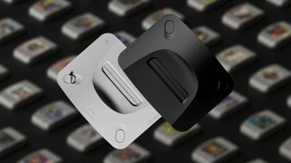 Analogue 3D consoles in white and black with blurred games on black surface in backdrop.