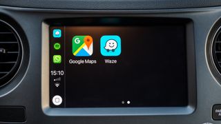 Google Maps and Waze icons on a car dashboard