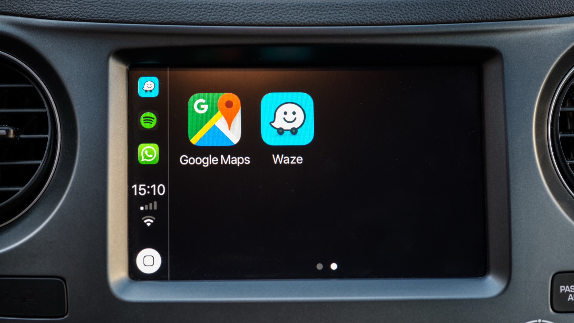 Google Maps and Waze icons on a car dashboard 