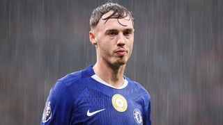 Cole Palmer of Chelsea looks on in the pouring rain during the Premier League match between Manchester United and Chelsea at Old Trafford on September 20, 2025 in Manchester, England. 