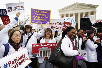 Affordable Care Act supporters rally in front of the Supreme Court