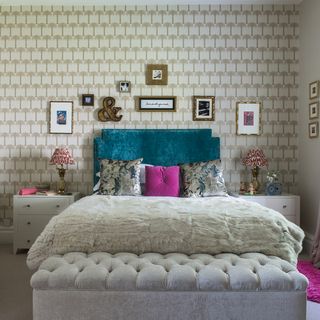 bedroom wall with light brown shades and bedding with multicolour cushions and throw and picture frames