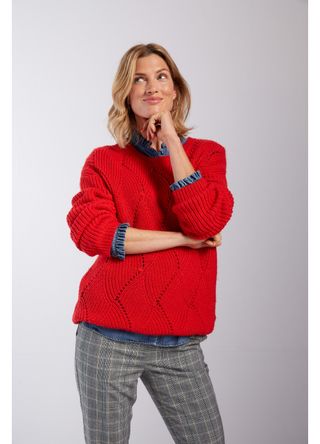 Model wear red jumper over denim shirt with checked trousers