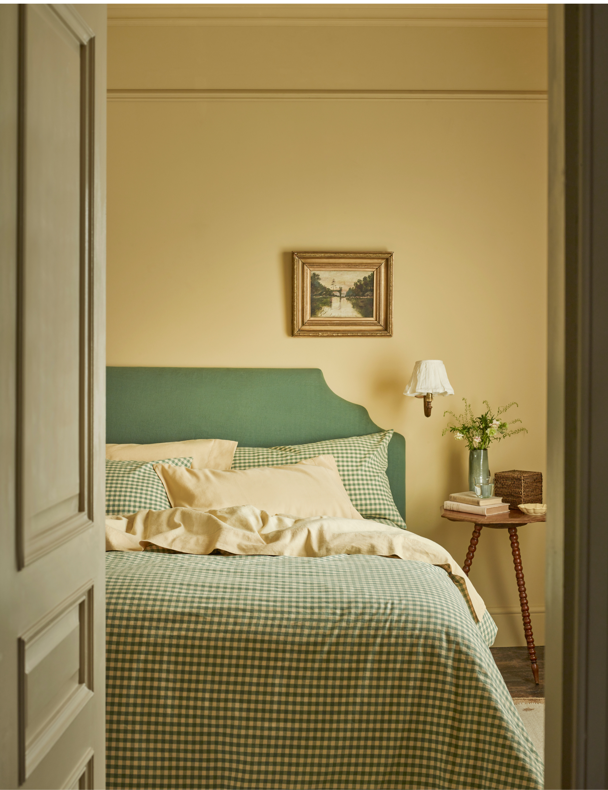 Cheerful butter yellow bedroom with coordinating butter yellow and green gingham bed sheets