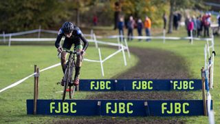 Cyclocross rider shows the way to bunny hop an obstacle