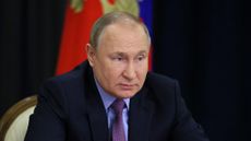 Vladimir Putin hosting a meeting in the Kremlin via video link