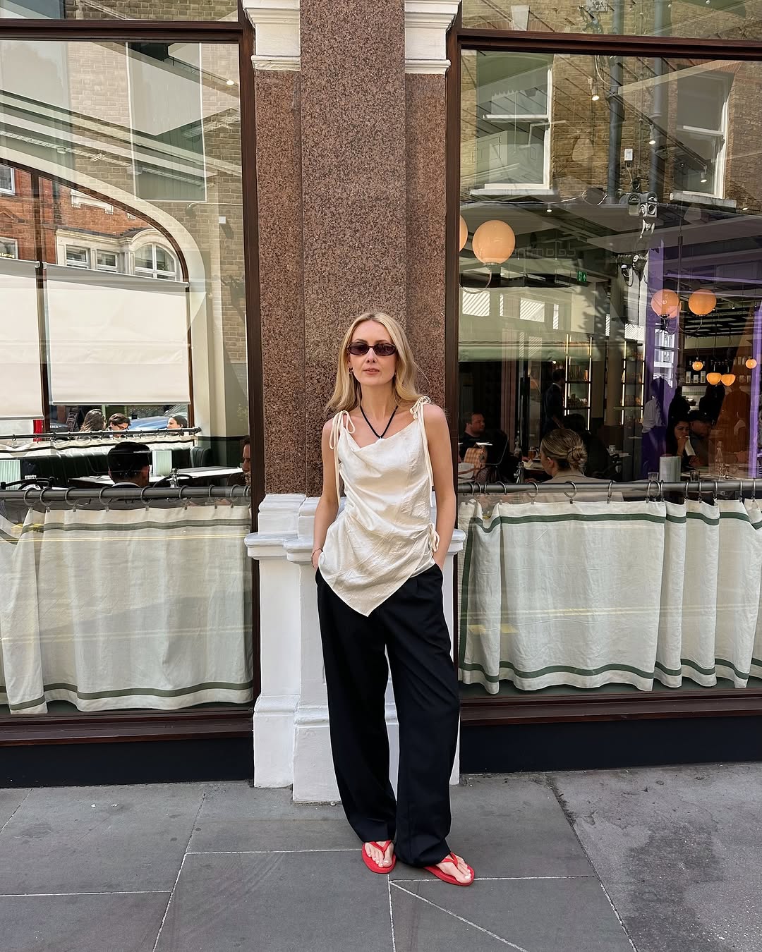 Woman wearing trouser pants and flip flops summer 2025.