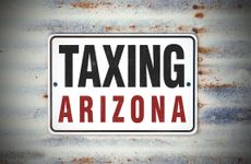 rustic sign saying Taxing Arizona