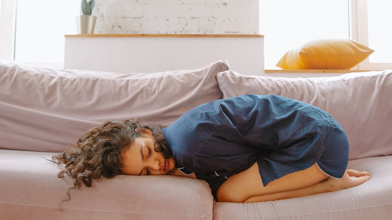 Woman napping on sofa