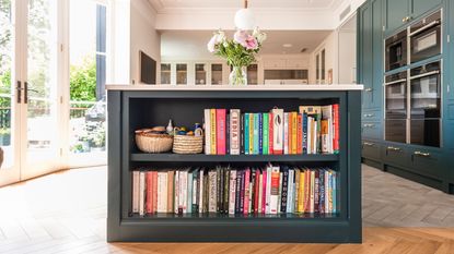 Kitchen with island with bookshelf on end